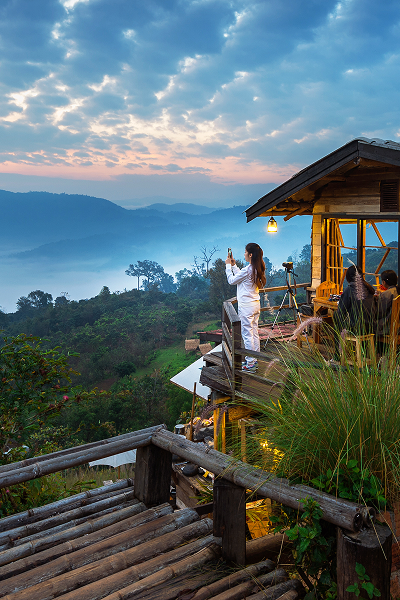 woman taking photo morning mist phu lang ka phayao thailand 1